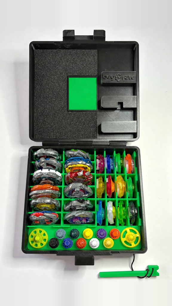 Beycrate 1 in Green, open and loaded with 12 Beyblade X blades, ratchets and bits