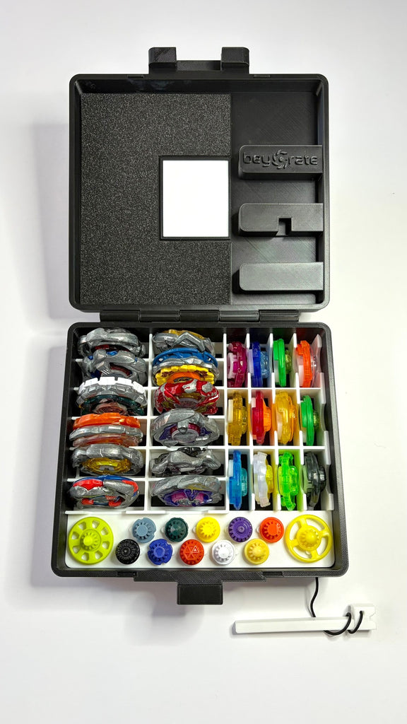 Beycrate 1 in White, open and loaded with 12 Beyblade X blades, ratchets and bits