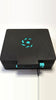 Beycrate 1 in Hyper Cyan, closed, showing the matte-black shell, cyan lock pin and Beycrate logo tile